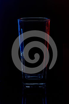 Silhouette of a glass with water on a black background