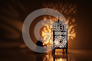 Silhouette of glowing Moroccan ornamental lantern with bronze tea cup. Decorative golden shadows. Greeting card