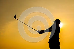 Silhouette of Golfer Drive Golf with Orange Background