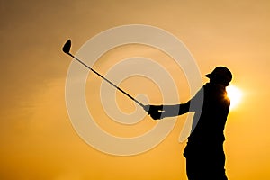 Silhouette of Golfer Drive Golf with Orange Background