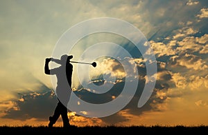 Silhouette golfer playing golf at beautiful sunset