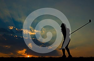 Silhouette golfer playing golf at beautiful sunset