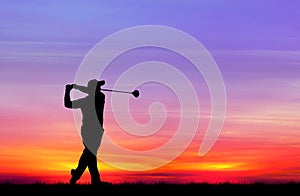 Silhouette golfer playing golf at beautiful sunset