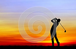 Silhouette golfer playing golf at beautiful sunset