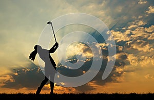 Silhouette golfer playing golf at beautiful sunset