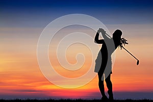 Silhouette golfer playing golf at beautiful sunset photo