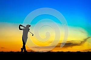 Silhouette golfer playing golf at beautiful sunset