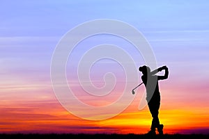 Silhouette golfer playing golf at beautiful sunset