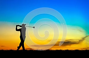 Silhouette golfer playing golf at beautiful sunset