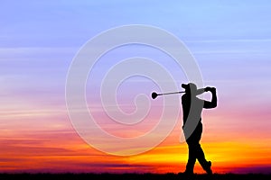 Silhouette golfer playing golf at beautiful sunset