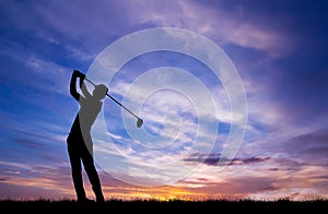 Silhouette golfer playing golf at beautiful sunset