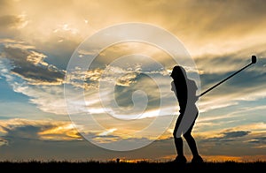 Silhouette golfer playing golf at beautiful sunset