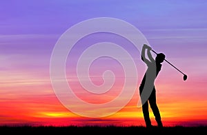 Silhouette golfer playing golf at beautiful sunset