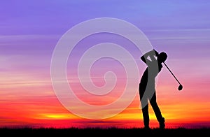 Silhouette golfer playing golf at beautiful sunset