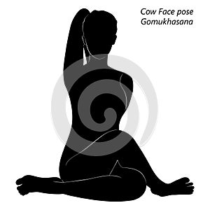 Silhouette of Gomukhasana yoga pose.