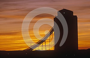 Silhouette of grain silo, sunset