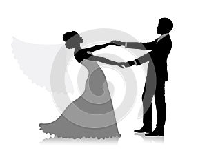 Silhouette of a groom holding his bride. The veil of the bride is flying.