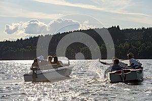 Silhouette of people racing with powerboats