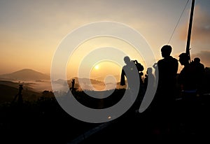 Silhouette group of people waiting and enjoy sunrise moment