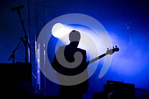 Silhouette of a guitar player on the stage
