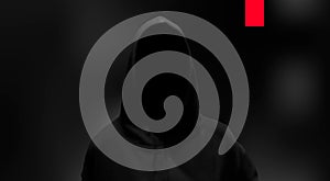 Silhouette of a hacker on black background, hacking of a computer system, theft of data concept