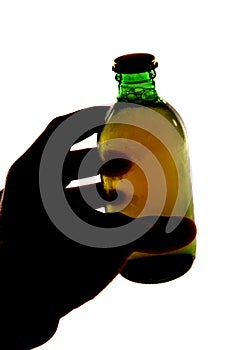 Silhouette of hand holding bottle of larger