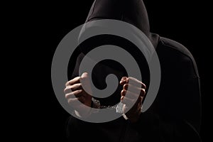 Silhouette of handcuffed male in hoodie, dangerous criminal punished by law