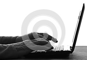 Silhouette of hands of an elderly woman typing