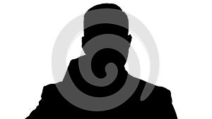 Silhouette Handsome businessman with headset looking into camera and smiling.
