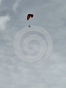 Silhouette of hangglider in sky photo