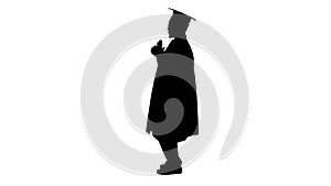 Silhouette Happy african american male student in graduation robe posing with diploma for camera.