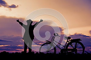 Silhouette happy Asian hipster women with bicycle