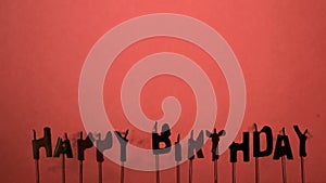 Silhouette of happy birthday candles being extinguished