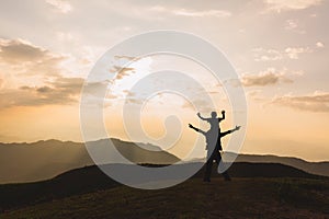 Silhouette of happy boy riding his father\'s neck Watch the nature.