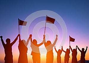 Silhouette of happy business team making high hands and holding