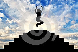 Silhouette of a happy business woman in a jump