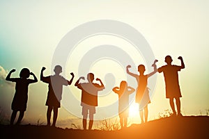 Silhouette of a happy children and happy time with sunset.