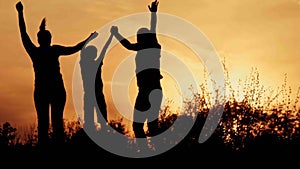 Silhouette, happy children with mother and father, family at sunset