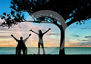 Silhouette happy disabled and guardian
