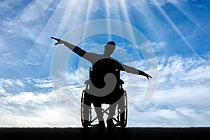 Silhouette of happy disabled man in wheelchair