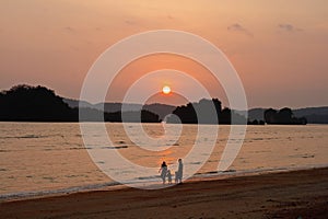 Silhouette of happy family on the beach