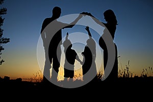 Silhouette of a happy family with children