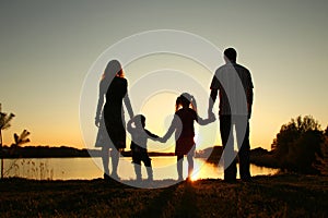 Silhouette of a happy family with children