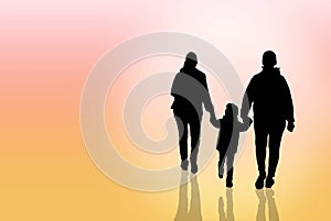 The silhouette of a happy family is father, mother and son walking in sunset.