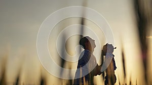 Silhouette of a happy family. A father plays with his little daughter. The father throws the child at sunset, the Family