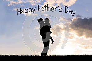 Silhouette of Happy Father Lovingly Hugging Little Child Outside