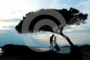 Silhouette of a happy loving couple at sunset on the seashore