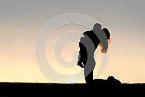 Silhouette of Happy Mother Playing Outside with Young Child
