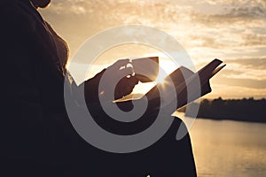 Silhouette of happy old women reading a book