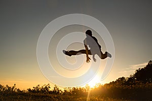Silhouette of happy people jumping in sunset on the Moutain photo